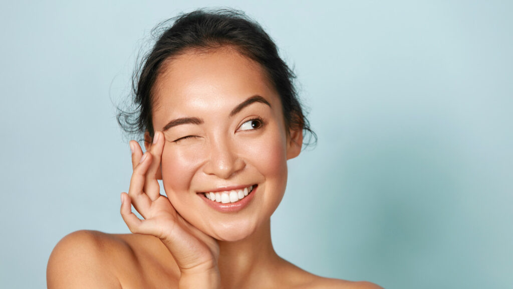 Woman winking one eye and looking to the left