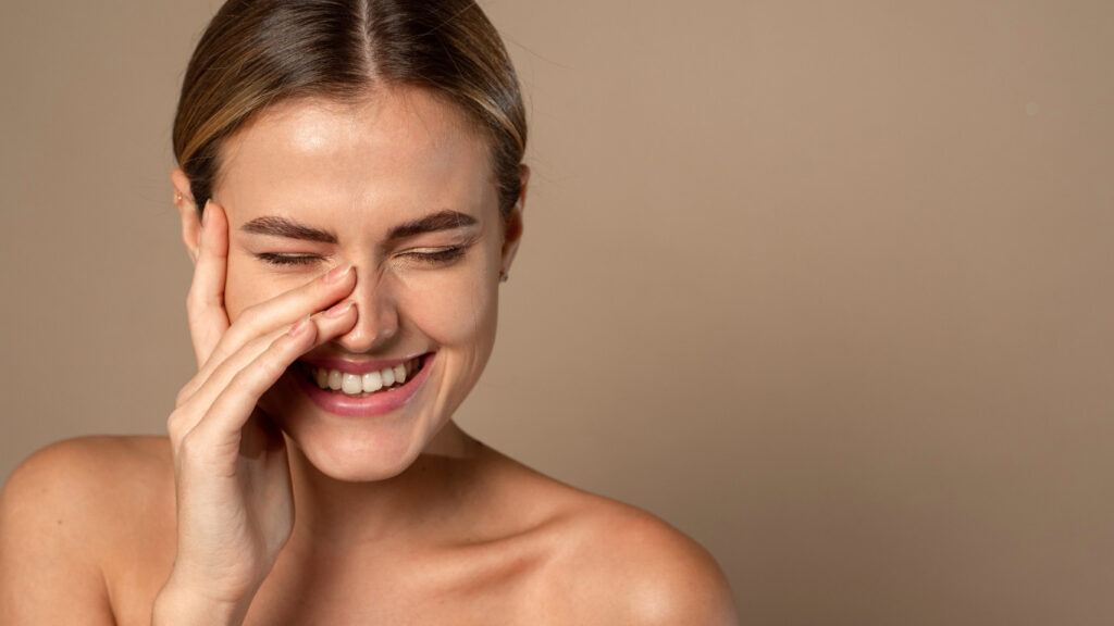 Smiling woman touching her face
